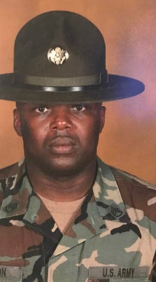 Army portrait of our owner in a campaign hat and woodland uniform with a U.S. Army tape