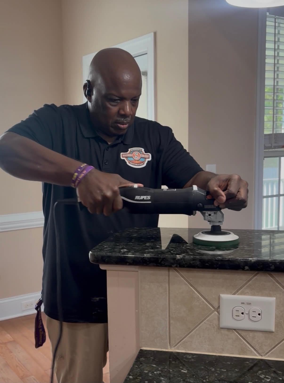 Polishing a granite countertop with a variable-speed buffer
