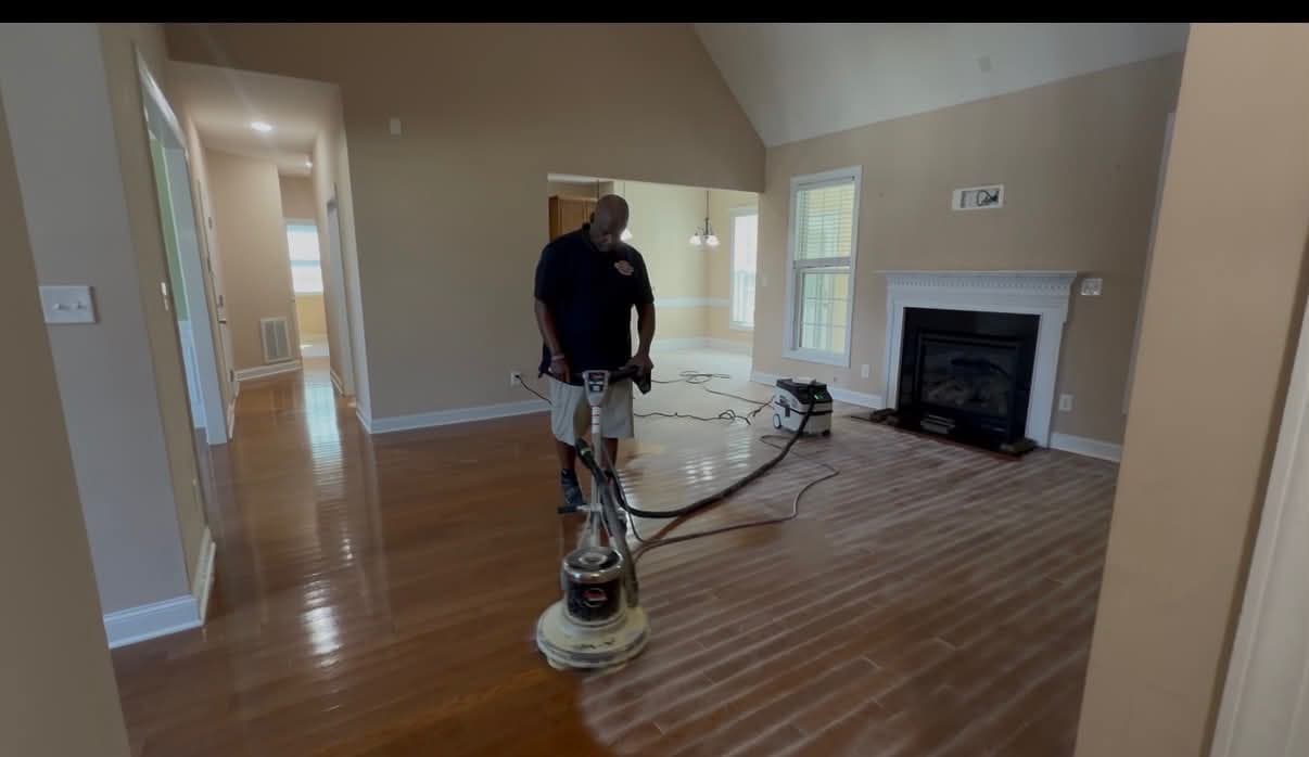 Buffing a hardwood living room floor